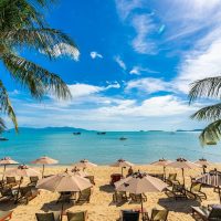 jamaica-jumbo-2 Beautiful tropical beach sea and ocean with coconut palm tree and umbrella and chair on blue sky and white cloud for holiday vacation travel